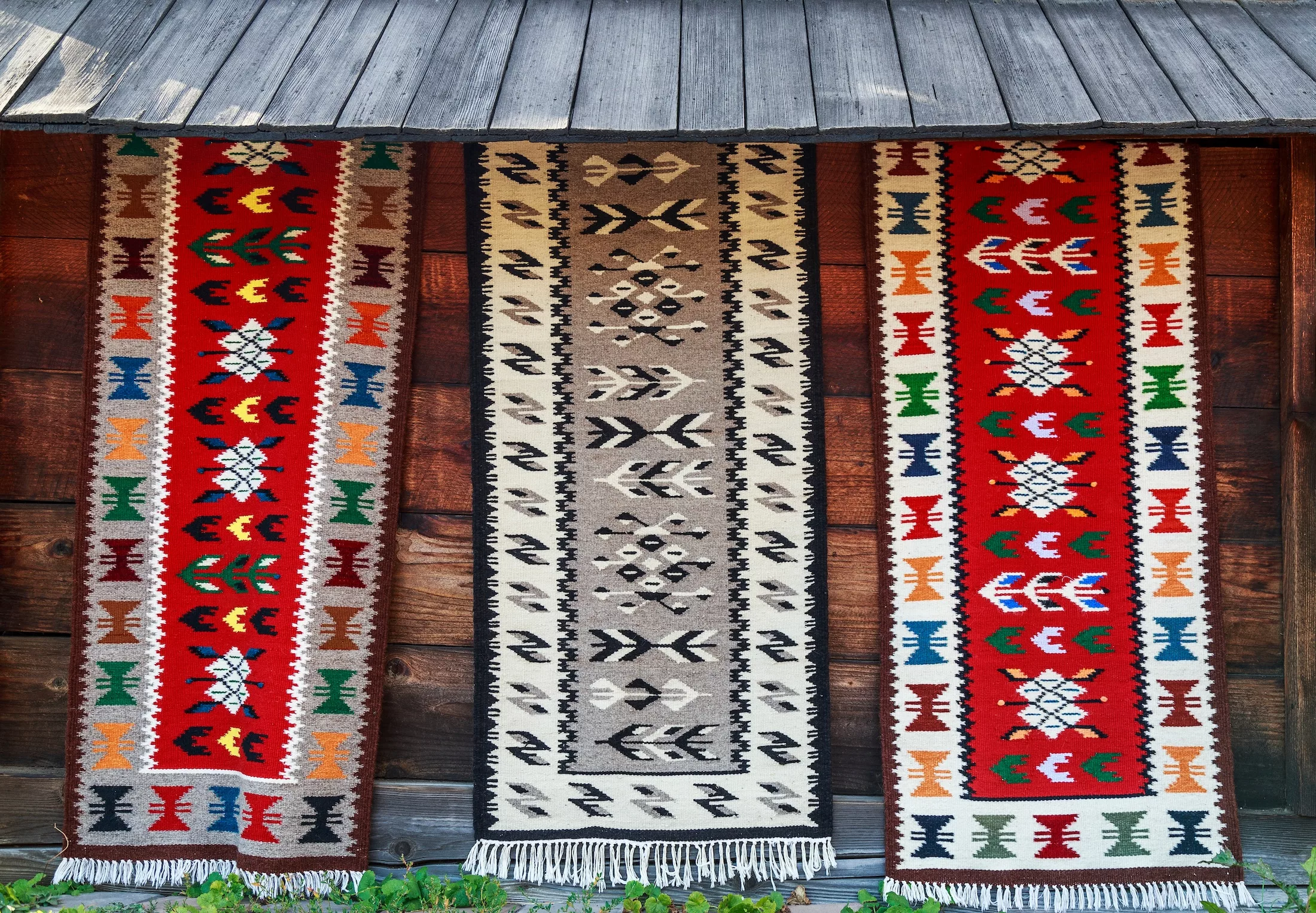 Traditional handmade rugs from Bucovina with different colors and drawings. Romanian rugs from presentation