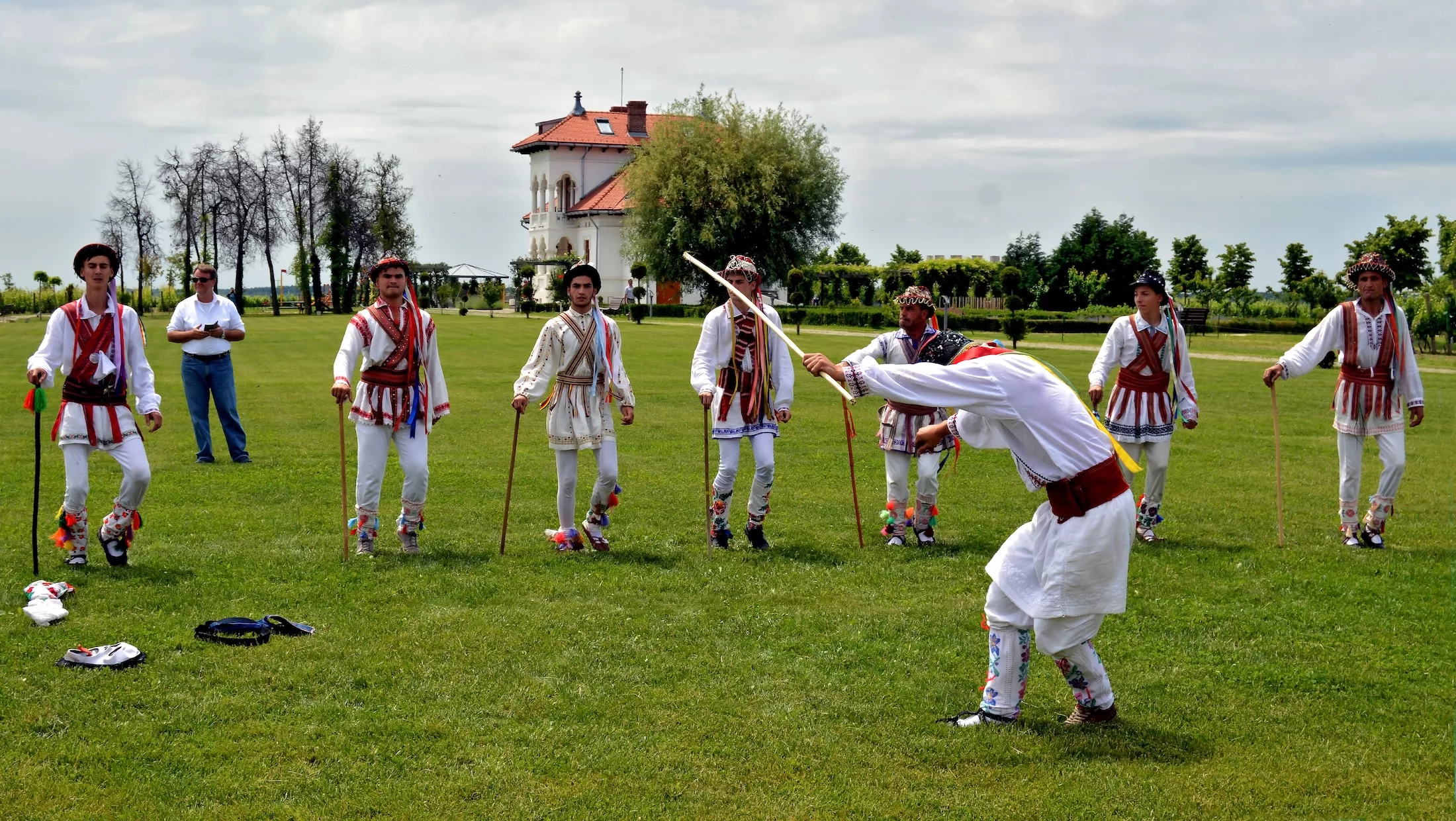 Romanian rustic festivities of "Calusari", men dressed in colorful clothing dancing in a spring festival after Easter, Dragasani, Dolj / Romania - 5/28/2018