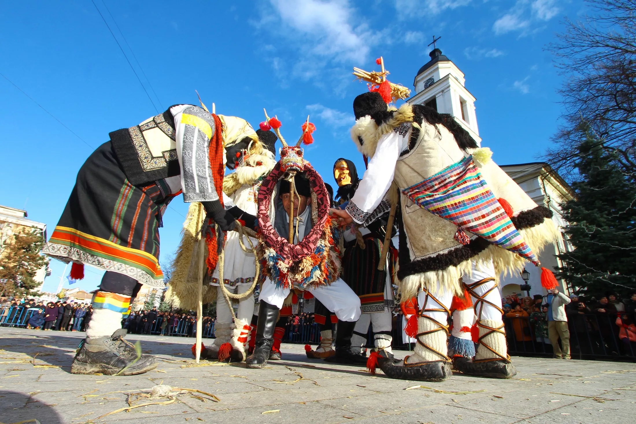 Suceava, Romania - December 27, 2016: Boys dress as old men in national costumes and a man in goat costume perform traditional dance during annual festival of winter pagan rituals of Malanca.