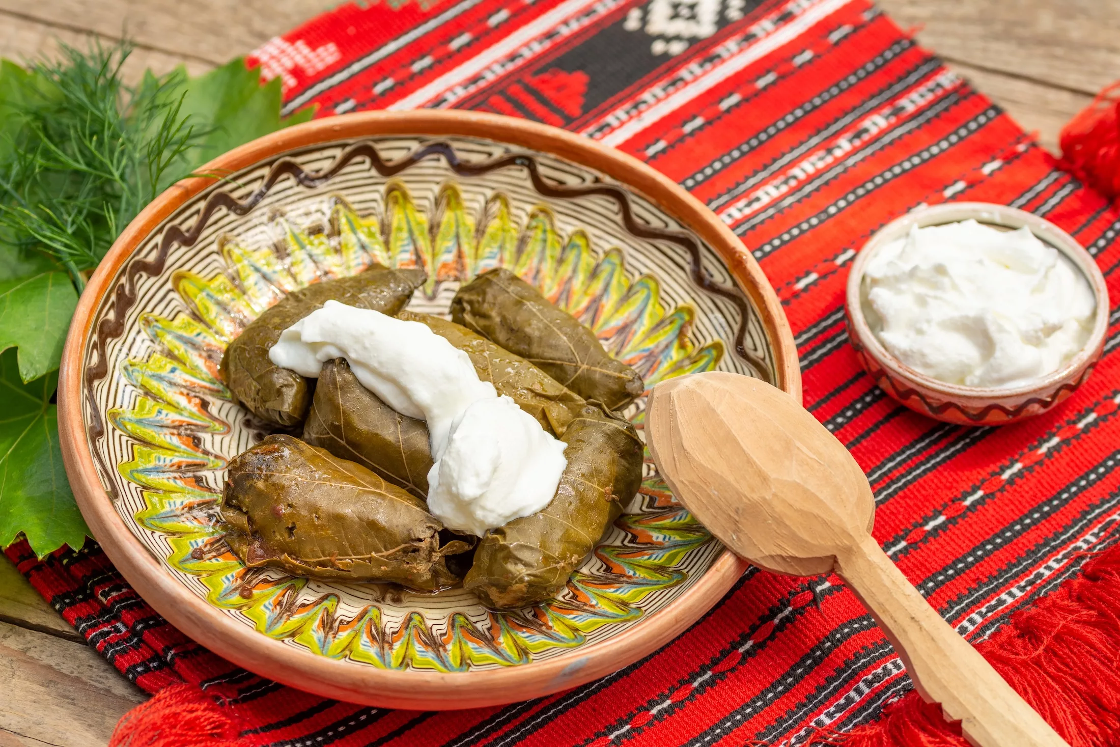 minced meat suffed grape leaves, balkan traditional food, on a decorated plate