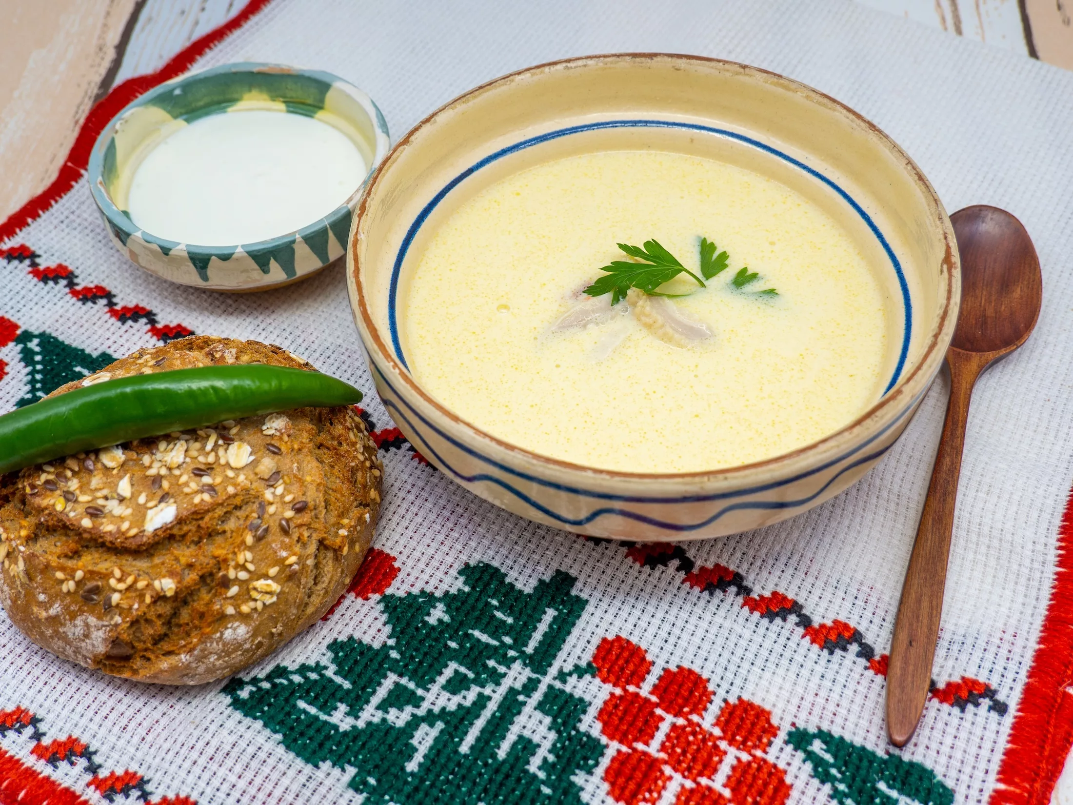 romanian beef tripe soup served with hot pepper and sour cream aside