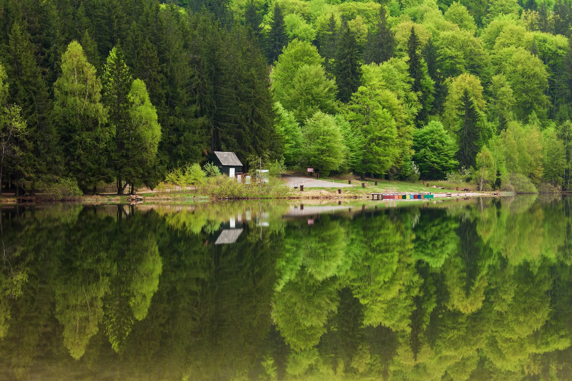 Saint Ana Lake in Romania - House on a lake with reflation into forest